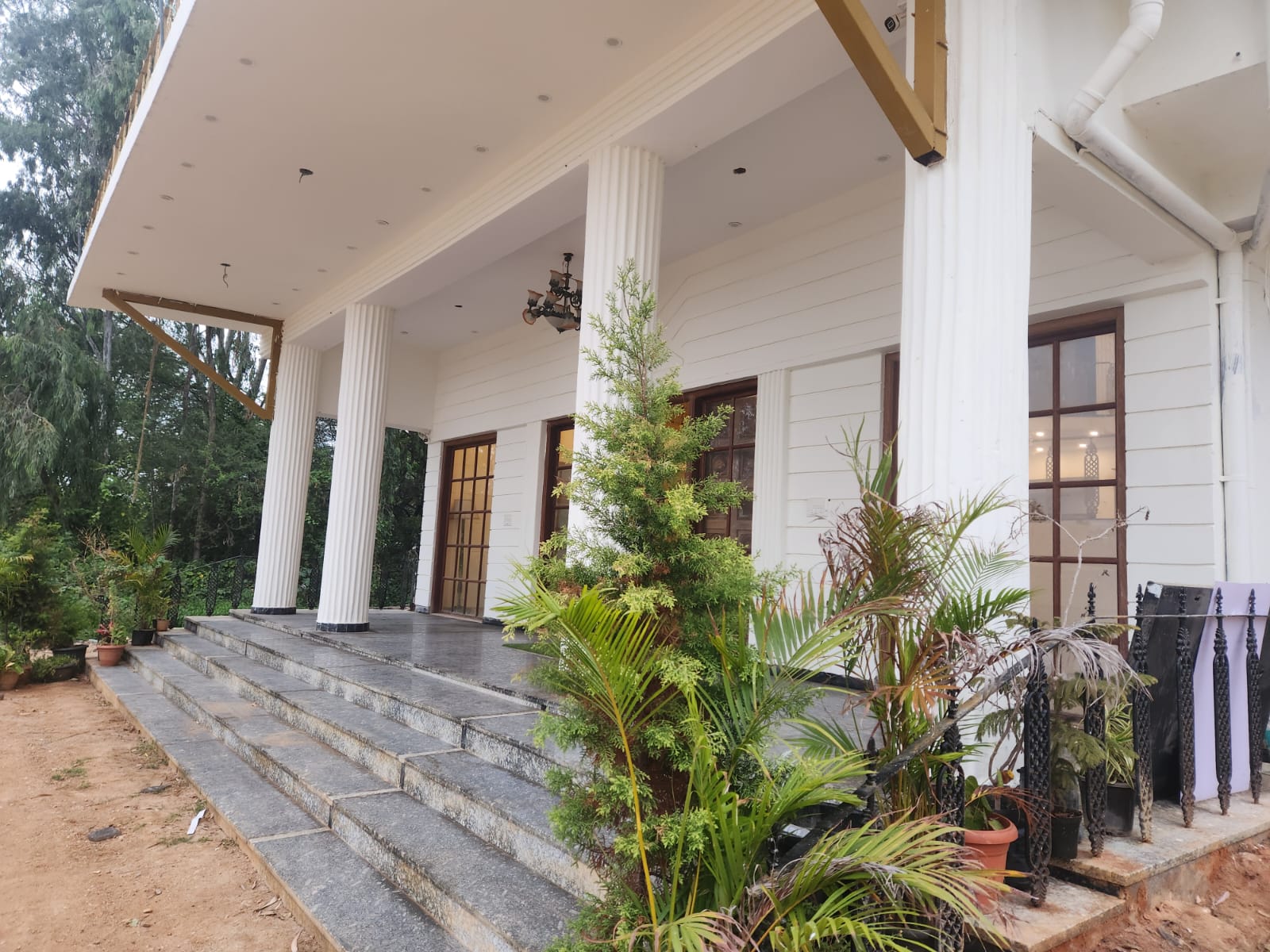 Vill Resort — Grand Halls, Pool & Lush Grounds ( 5 ) — Walkway & Gate Title:** Gated Approach Road & Entry Drive